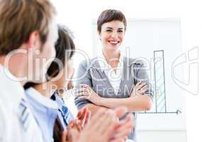 Portrait of a smiling businesswoman talking at her colleague dur