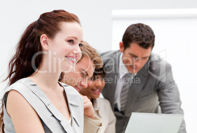 Portrait of a smiling businesswoman working with her colleagues
