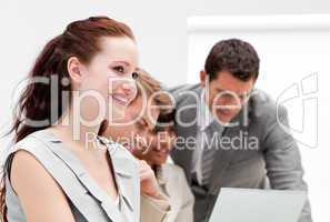 Portrait of a smiling businesswoman working with her colleagues