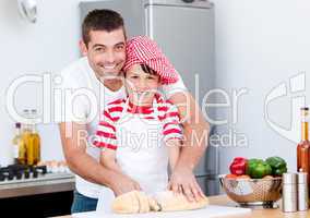 Portrait of a smiling father and his son preparing a meal