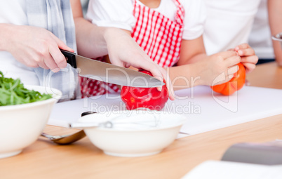 Close-up of people preparing a meal