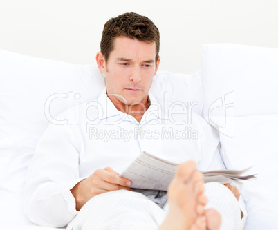 Handsome man reading a newspaper