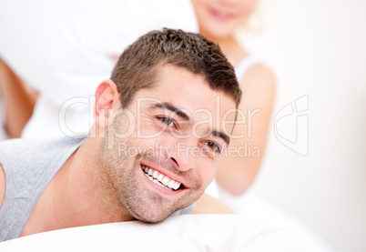 Handsome man lying on the bed