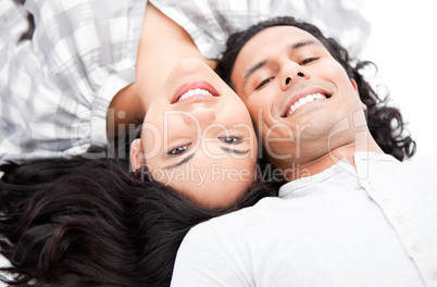 Laughing couple relaxing on the floor