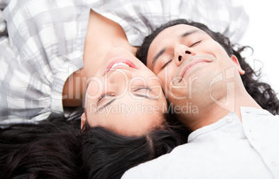 Smiling couple relaxing on the floor