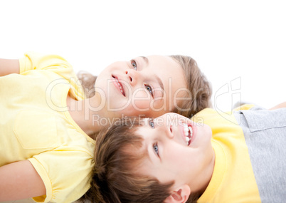 Smiling childrens lying on the floor together