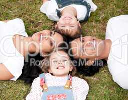Positive family lying on the floor together