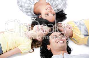 Smiling family lying on the floor together