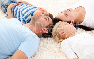 Happy family lying on the floor together