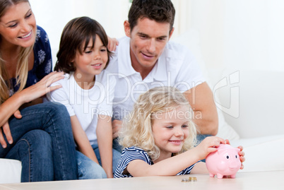 Positive family using a piggy bank