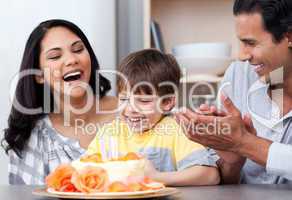 Laughing family celebrating a birthday together