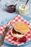 Scone with clotted cream and raspberry jam