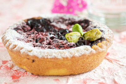 Small cake with prunes and pistachios