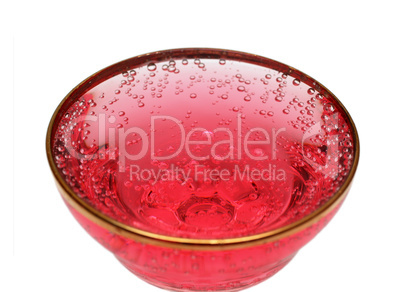 glass with red aerated water