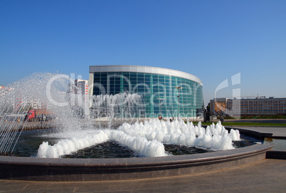 modern glass building and fountain