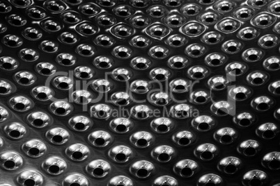 concave metal surface background with holes