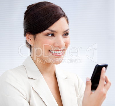 Radiant businesswoman using a mobile phone