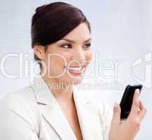 Radiant businesswoman using a mobile phone