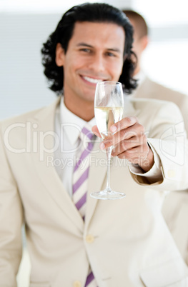 Cheerful businessman holding a glass of Champagne