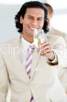 Cheerful businessman holding a glass of Champagne