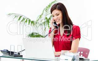 Portrait of a busy businesswoman talking on phone
