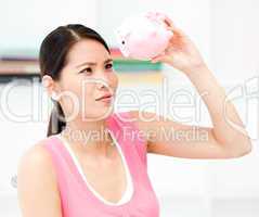 Portrait of an attractive businesswoman holding a piggy-bank