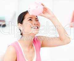 Portrait of a smiling businesswoman holding a piggy-bank