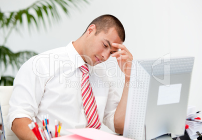 Stressed businessman working at a computer