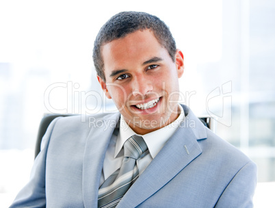 Attractive young businessman sitting at his desk