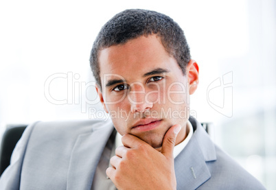 Portrait of a pensive latin businessman sitting at his desk