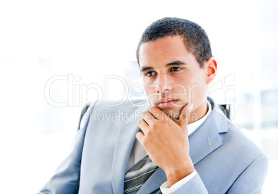 Portrait of a pensive young businessman sitting at his desk