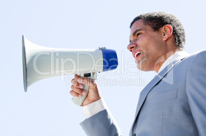 Charismatic businessman yelling through a megaphone