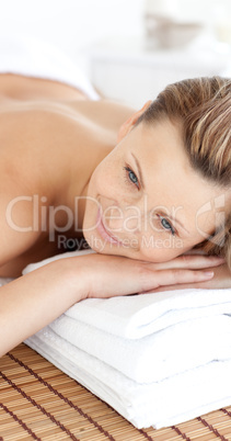 Close-up of a smiling woman having a massage with stones