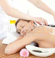 Portrait of a relaxed woman having a massage with stones