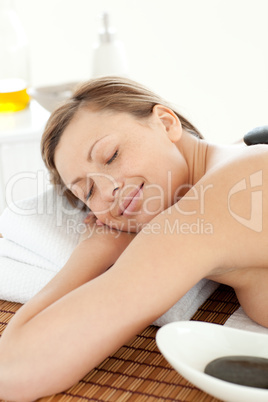 Portrait of a happy woman having a massage with stones