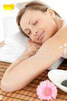 Portrait of a smiling woman having a massage with stones