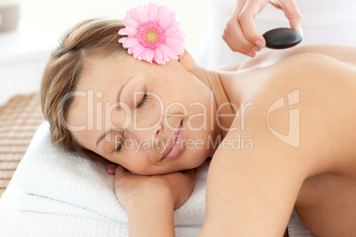 Portrait of a radiant woman having a flower