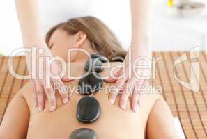 Cheerful woman lying on a massage table