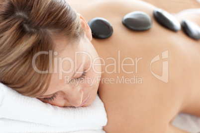 Close-up of a bright woman having a stone therapy