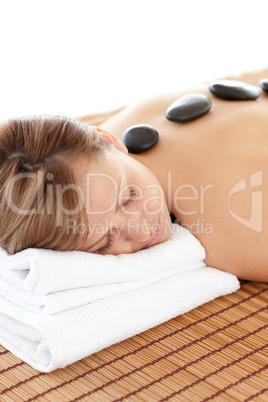 Delighted woman having a stone therapy