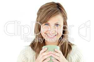 Smiling woman holding a cup a coffee