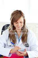 Happy female doctor writing her diagnosis