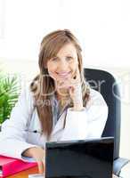 Attractive female doctor working with a laptop