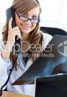 Happy female doctor talking on the phone