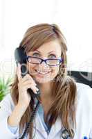 Smiling female doctor talking on the phone