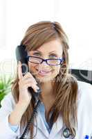 Beautiful female doctor talking on the phone