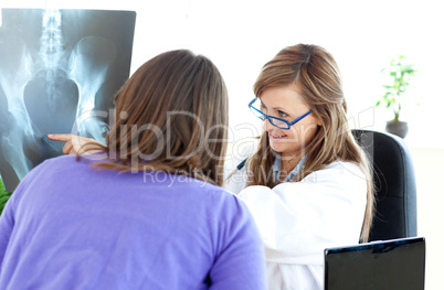 Delighted female doctor pointing an x-ray