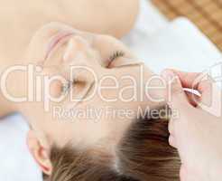 Acupuncture needles on an attractive woman's head