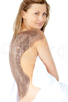 Attractive woman enjoying a mud skin treatment