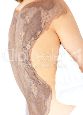 Close-up of a woman enjoying a mud skin treatment